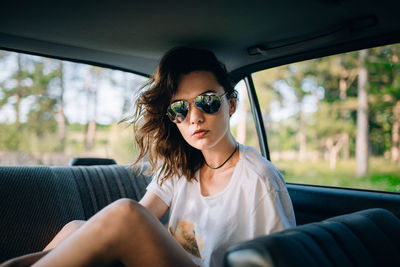 Beautiful woman sitting in car