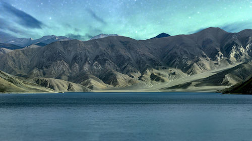 Scenic view of lake and mountains against sky