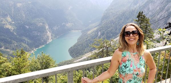 Portrait of smiling woman against mountains