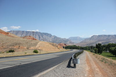 Empty road leading towards mountains