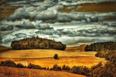 Scenic view of landscape against cloudy sky