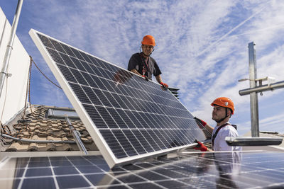 Engineers together installing solar panels
