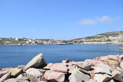 Scenic view of sea by city against sky