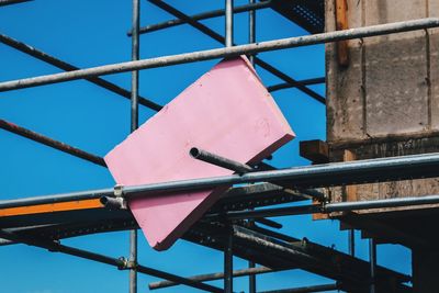 Low angle view of scaffolding against clear blue sky