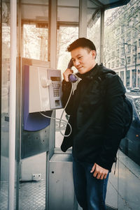 Man using telephone in city