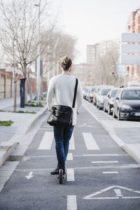 Rear view of man walking on road