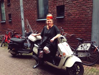 Woman riding motorcycle sitting in bus