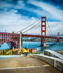 View of suspension bridge against cloudy sky