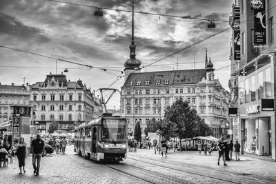 People walking on street amidst buildings in city