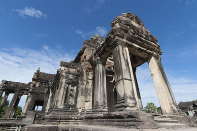 Low angle view of old temple against cloudy sky