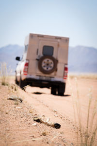 Close-up of vintage car on sand