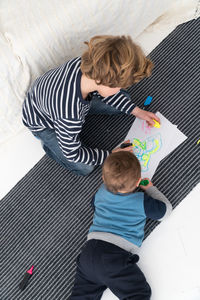 High angle view of mother and son playing at home