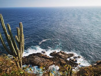 High angle view of rocks by sea against sky