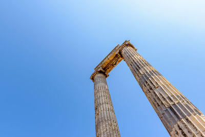 Low angle view of old building against blue sky