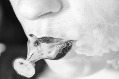 Close-up of woman exhaling smoke