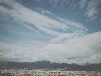 Cityscape against cloudy sky