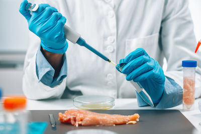 Midsection of man working on table