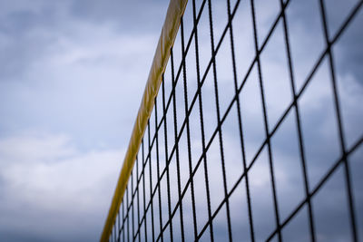 Low angle view of fence against sky