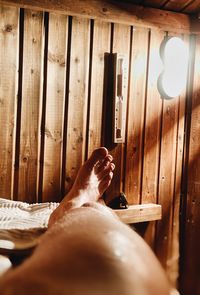 Low section of woman lying on wooden floor