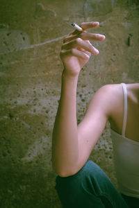 Midsection of woman holding cigarette