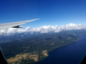 Cropped image of airplane flying over sea