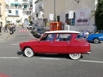 Car on street against buildings in city