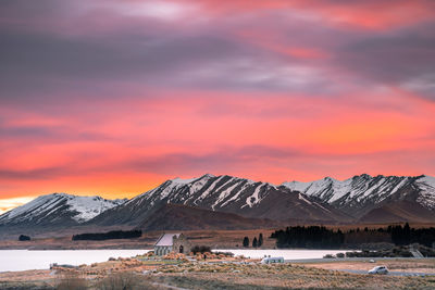 Sunrise view of the church of good shepherd with beautiful snow capped mountain range. 