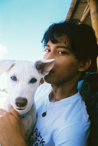Portrait of young man with dog
