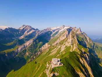 Scenic view of mountains against clear blue sky