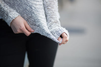 Midsection of woman standing in forest