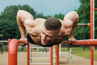 Portrait of young woman exercising in park