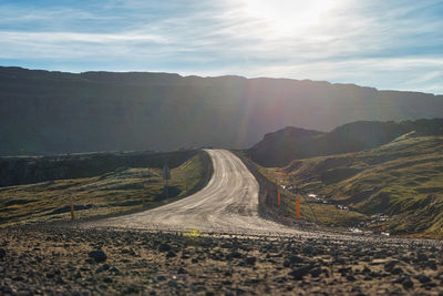 Scenic view of road and mountains against sky