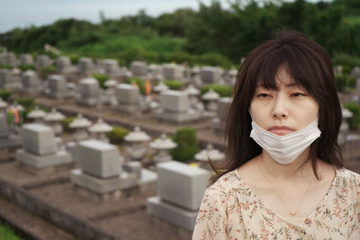 Portrait of a beautiful woman. visiting family's grave.