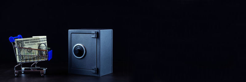 Close-up of telephone booth on table against black background