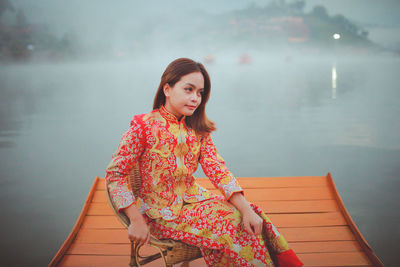 Asian woman wearing cheongsam traditional red dress on chinese new year travel.