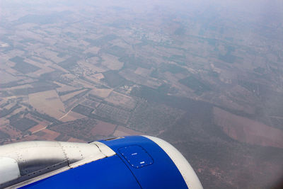 Aerial view of airplane flying over land