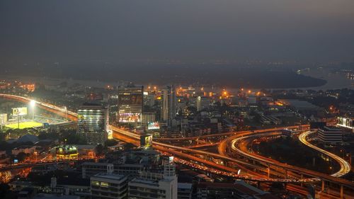 High angle view of illuminated city buildings at night