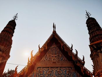 Low angle view of temple and building against sky