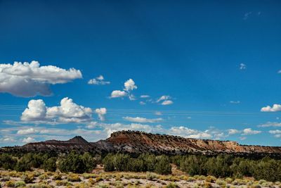 Scenic view of rocky mountains against blue sky