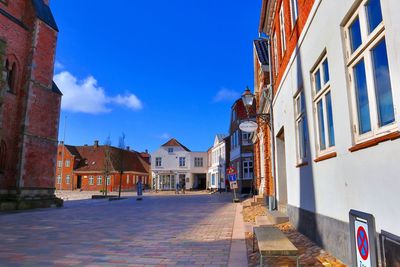 Footpath amidst buildings in town