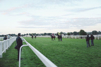 People walking on grassy field