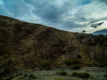 Low angle view of rocky mountain against sky