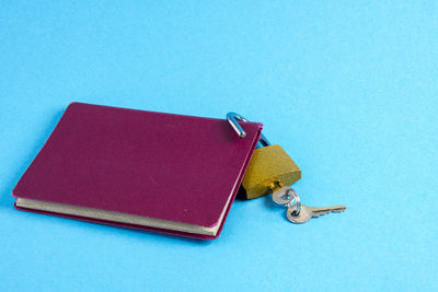 High angle view of book on table against blue background