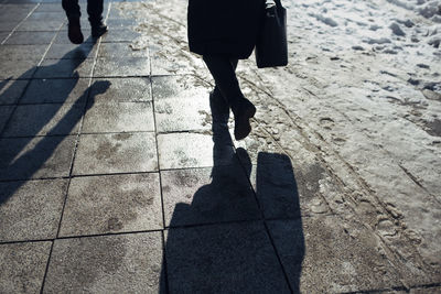 Low section of people walking on street