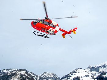 Low angle view of airshow against sky during winter