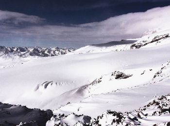 Scenic view of snow covered mountains against sky