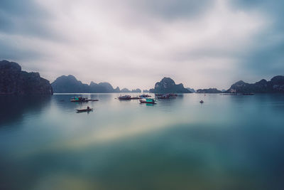 Boats on sea against sky