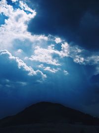 Scenic view of mountains against cloudy sky