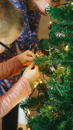 Shot of children decorating christmas tree