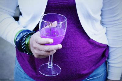 Midsection of woman holding cocktail